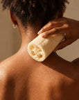 West African woman holding the Glow Loofah, based on the existing lifestyle image